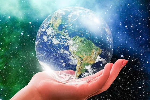 A woman’s hand holding a glass globe