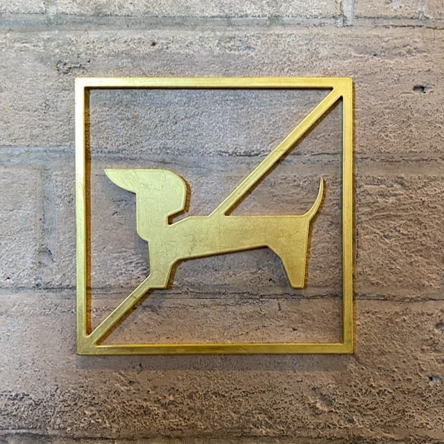 A plaque with a dachshund and a line through it
