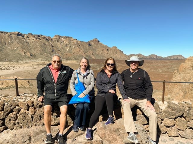 Four people in front of rocky cliffs