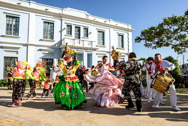 People in costumes dancing in the street