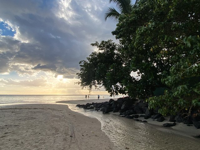 A shallow river running into the sea at dusk