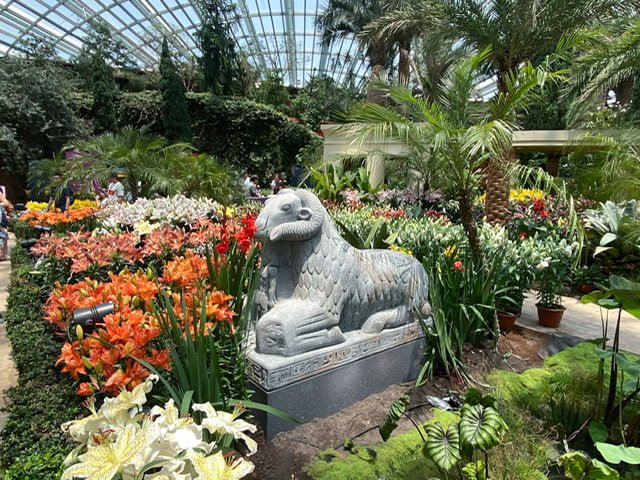 Flowers and a ram statue