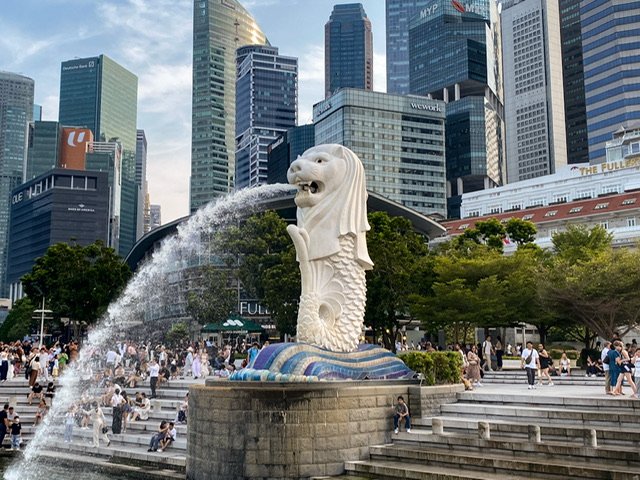 A statue with the head of a lion and the body of a fish spitting water